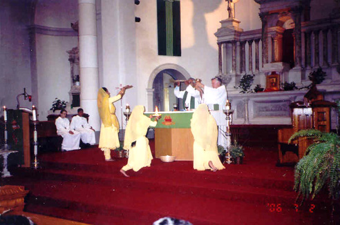 The Hindu dancing girls offer gifts during the mass
